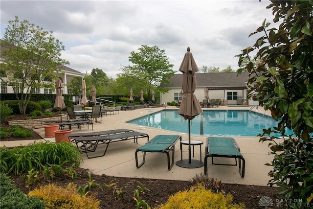 community pool with fence and a patio