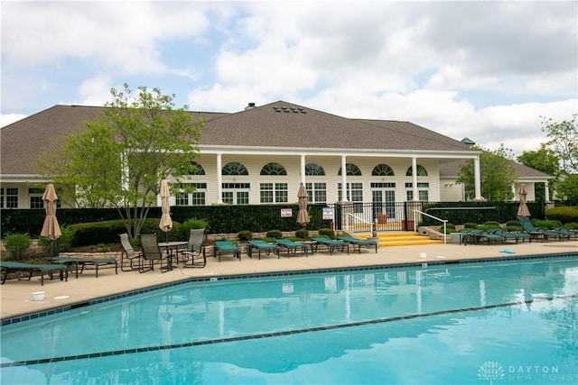 pool featuring fence and a patio