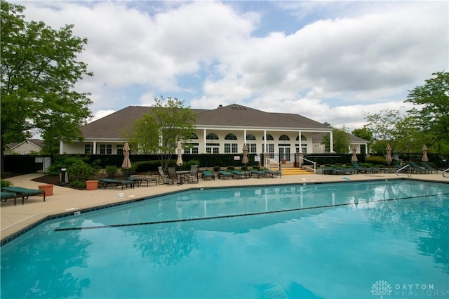 pool featuring a patio and fence