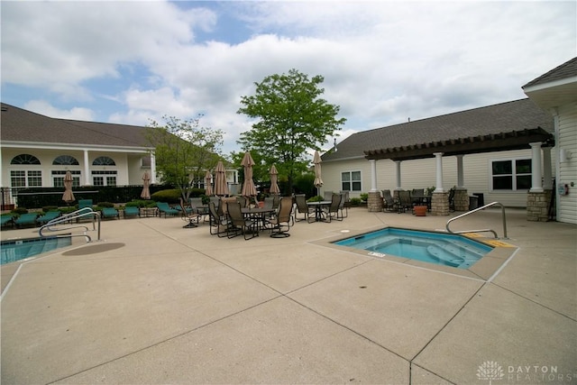 pool featuring a patio area and a hot tub