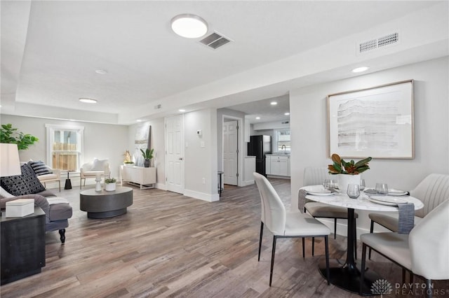 dining space with hardwood / wood-style flooring