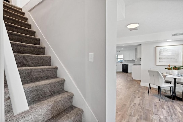 stairway featuring hardwood / wood-style flooring