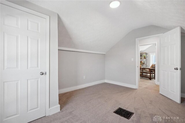 32 W Main St, Phillipsburg, OH 45354 - bonus room with lofted ceiling, carpet floors, baseboards, and a textured ceiling