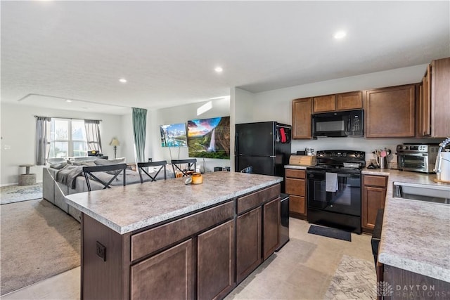 kitchen with black appliances and a kitchen island