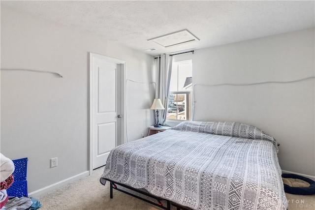 bedroom featuring a textured ceiling and carpet floors