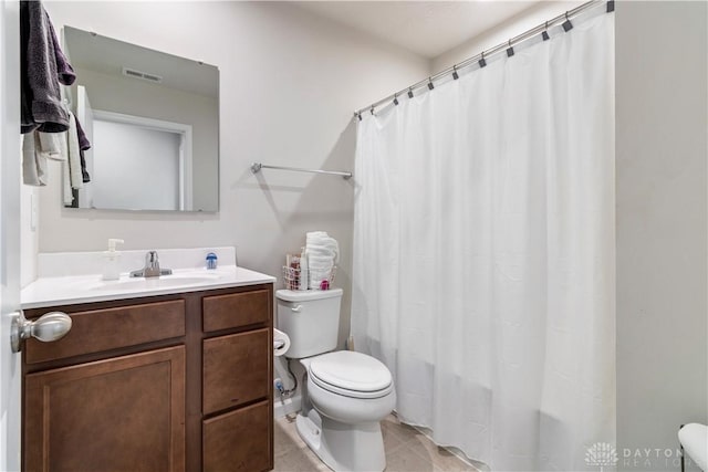 bathroom featuring tile patterned floors, toilet, and vanity