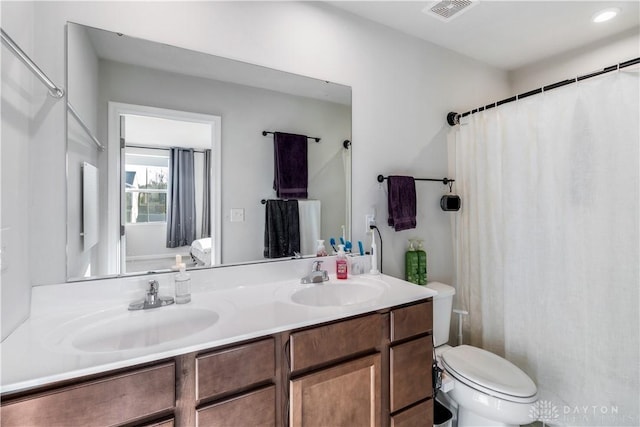 bathroom featuring toilet and vanity