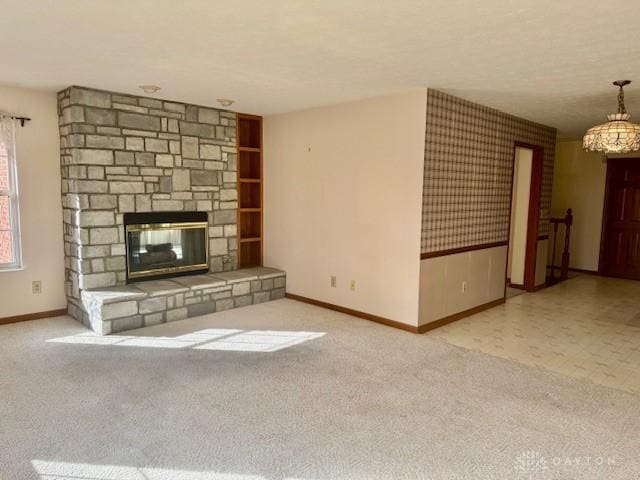 unfurnished living room with a stone fireplace