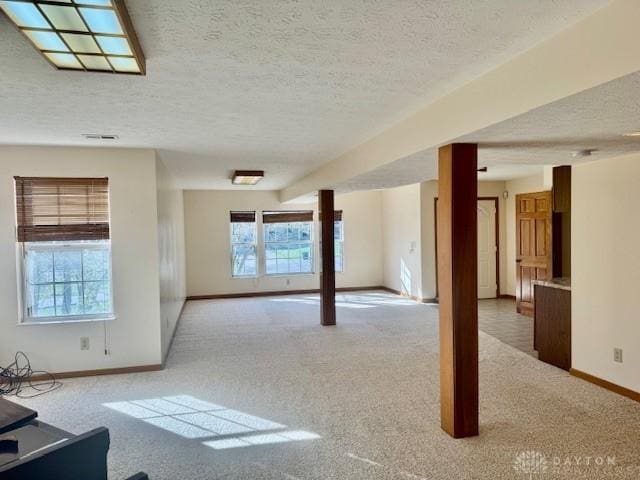 carpeted spare room featuring a textured ceiling