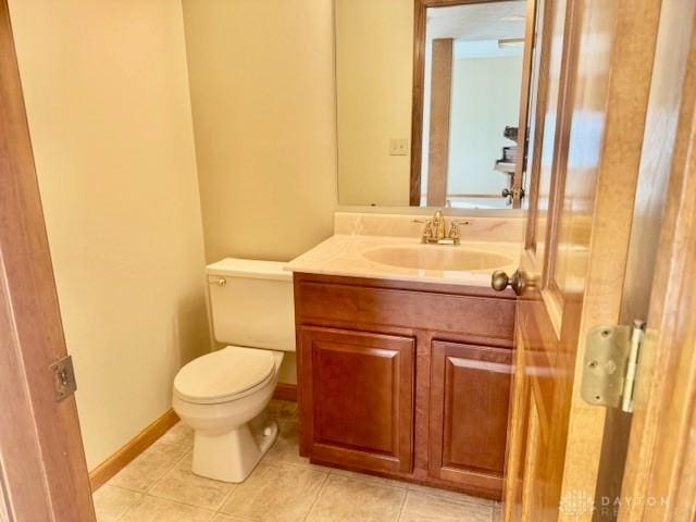 bathroom featuring tile patterned flooring, vanity, and toilet