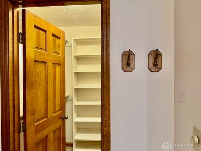 corridor with a textured ceiling