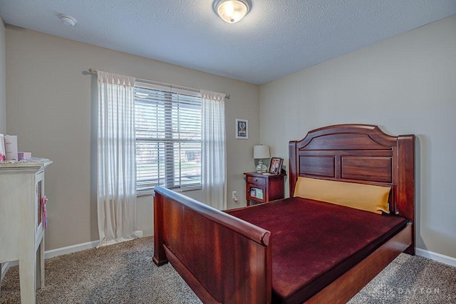 bedroom featuring carpet flooring and a textured ceiling