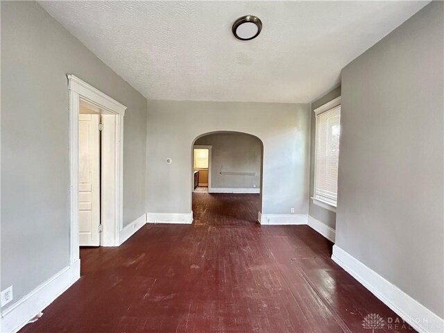 interior space with dark hardwood / wood-style flooring and a textured ceiling