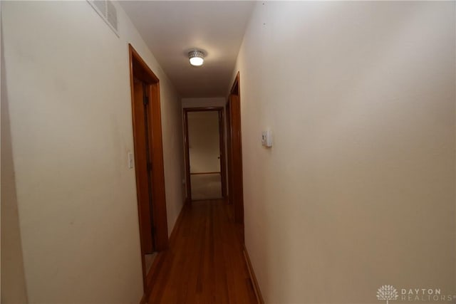 corridor with dark hardwood / wood-style floors