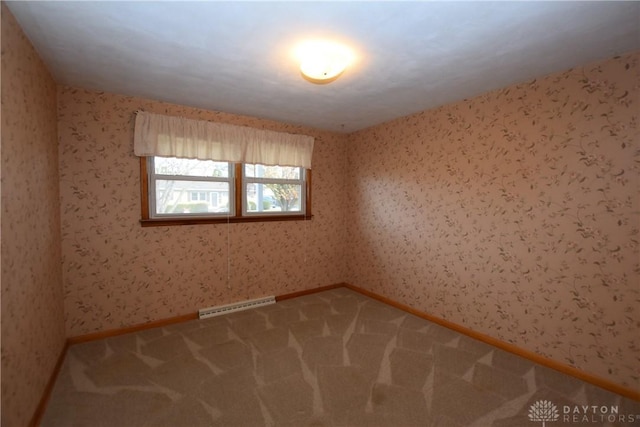 carpeted empty room with baseboard heating