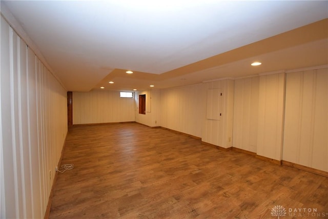 interior space with wood-type flooring and wooden walls