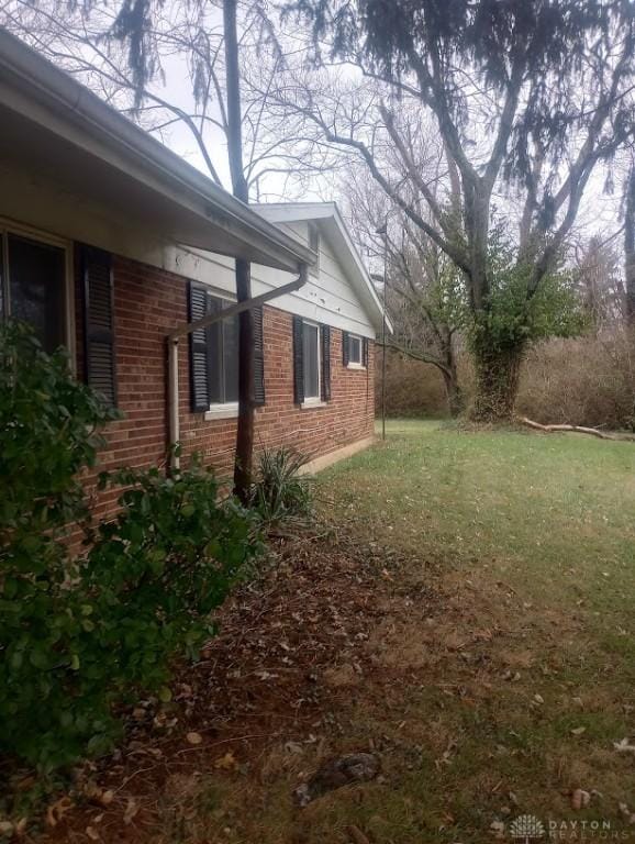 view of side of home featuring a lawn