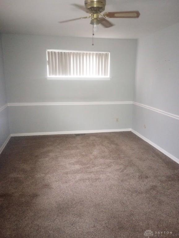 carpeted empty room with ceiling fan