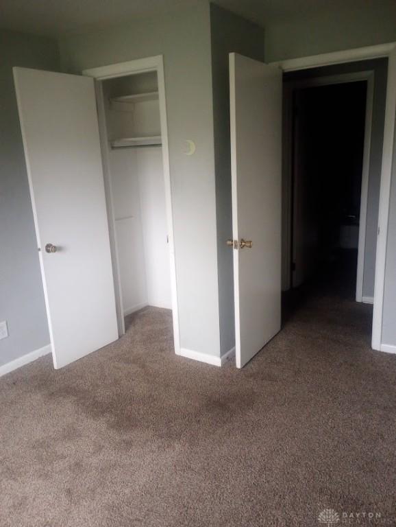 unfurnished bedroom with carpet and a closet