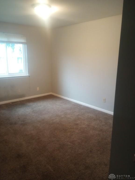 empty room with dark carpet