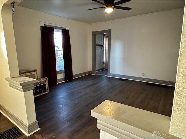 empty room with ceiling fan and dark wood-type flooring