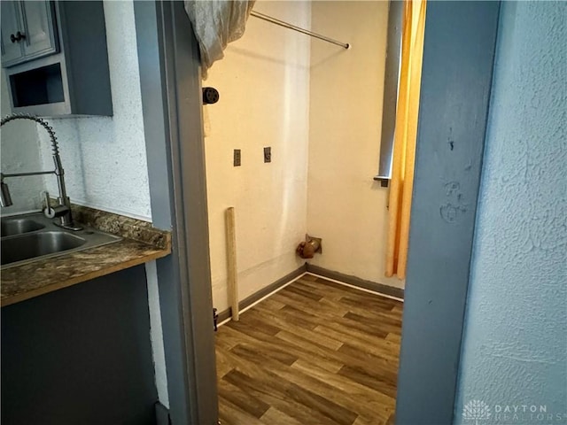 washroom with dark hardwood / wood-style flooring and sink