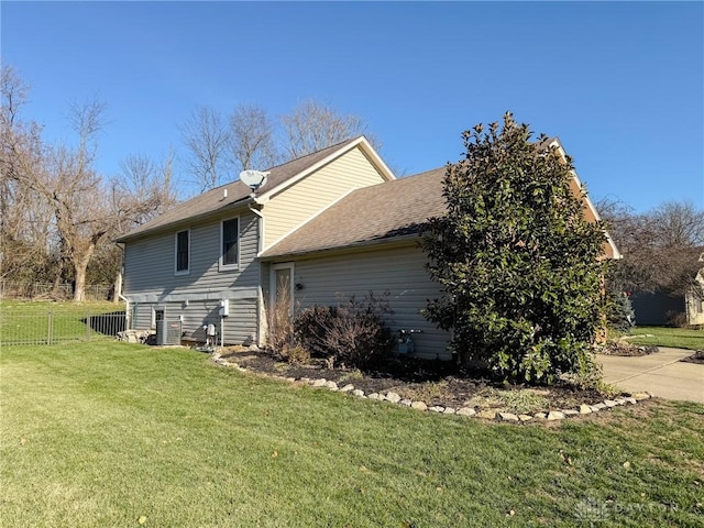 view of side of home featuring a lawn