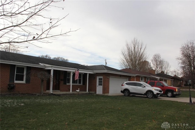 view of front of property with a front lawn, an attached garage, brick siding, and driveway