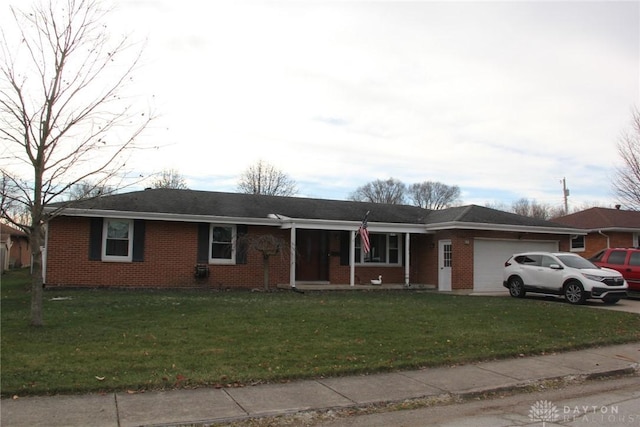 ranch-style home with a garage and a front lawn