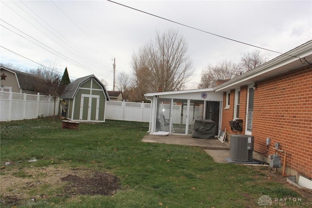 view of yard with a shed, a patio, and central AC unit