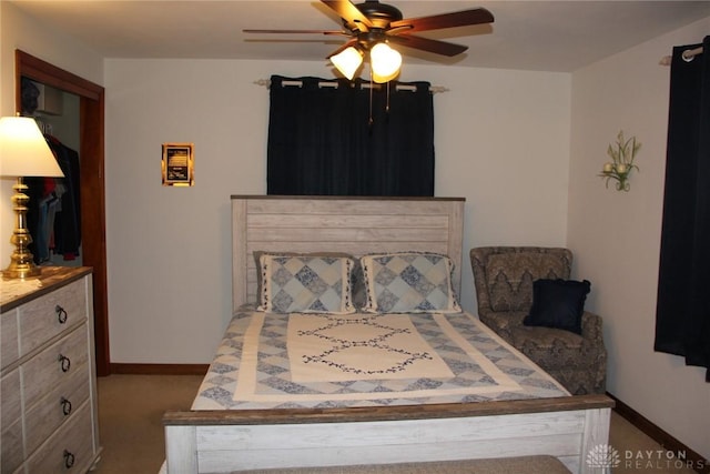 carpeted bedroom featuring baseboards and ceiling fan