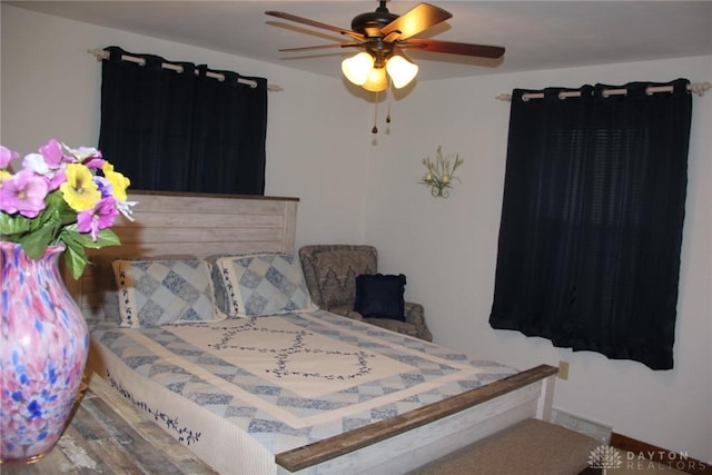 bedroom featuring a ceiling fan and baseboards