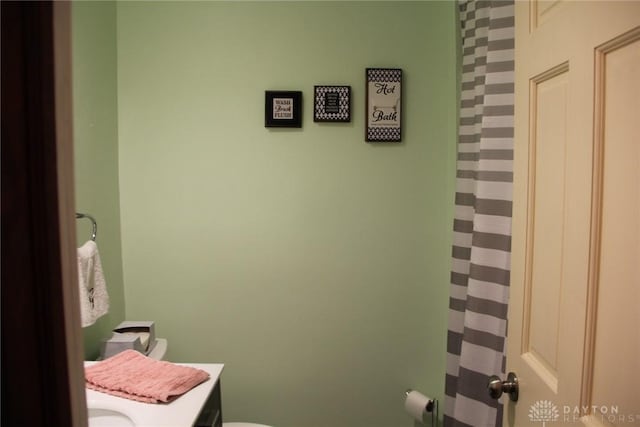 bathroom featuring toilet and vanity