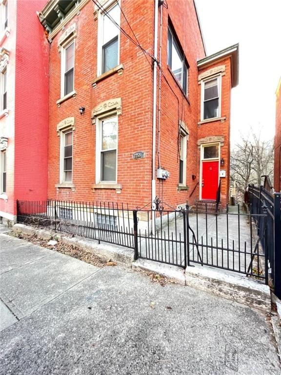 view of building exterior with a fenced front yard