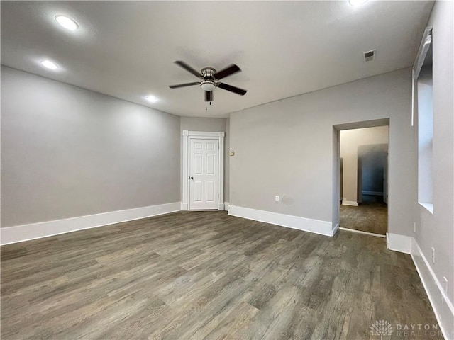 unfurnished room featuring a ceiling fan, visible vents, dark wood-style floors, baseboards, and recessed lighting