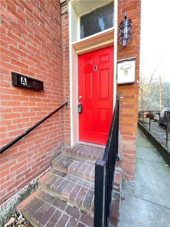 entrance to property with brick siding