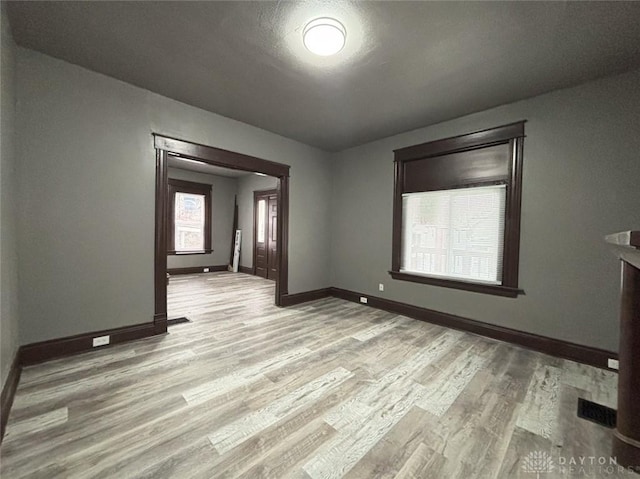 unfurnished room featuring light hardwood / wood-style floors