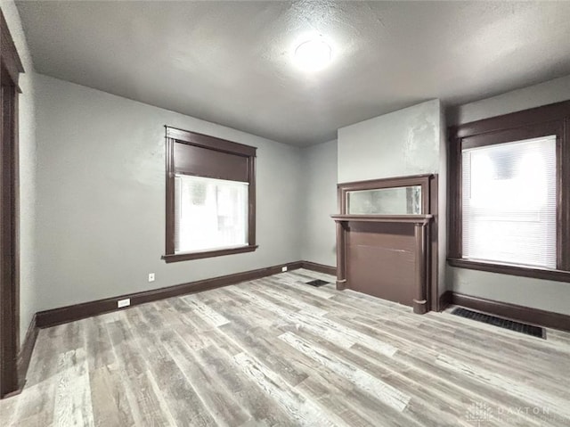 empty room with light hardwood / wood-style flooring