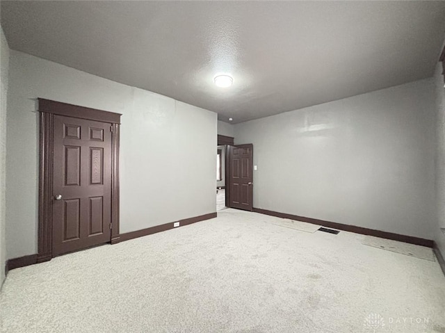 carpeted empty room with a textured ceiling