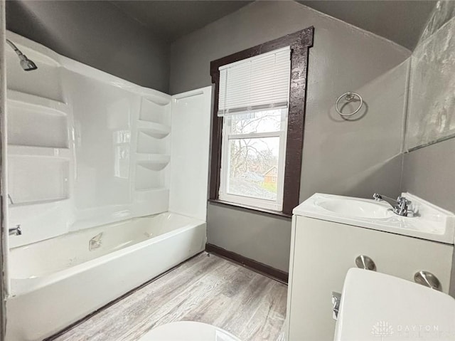 full bathroom featuring hardwood / wood-style floors, vanity, toilet, and bathtub / shower combination