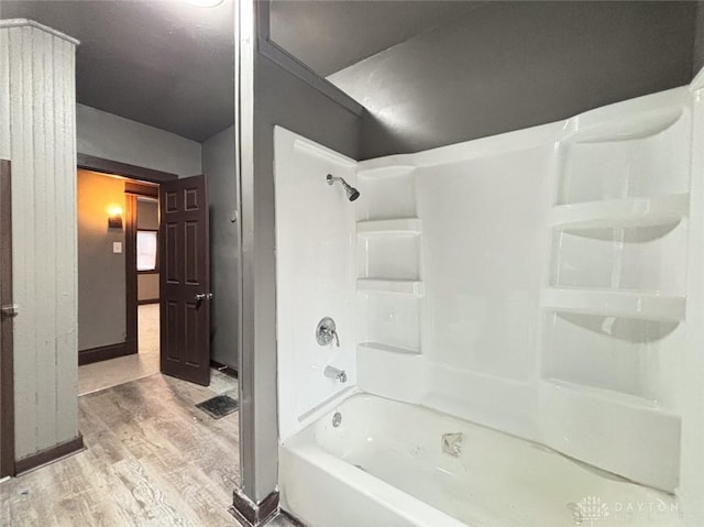 bathroom featuring hardwood / wood-style floors and shower / bathtub combination