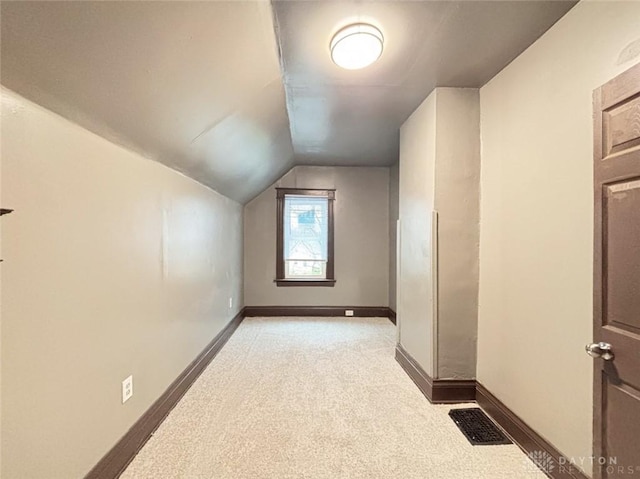 bonus room featuring light carpet and lofted ceiling