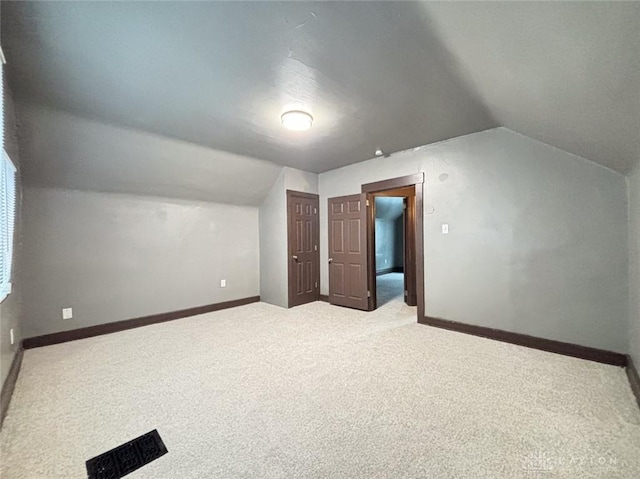 bonus room featuring carpet and vaulted ceiling