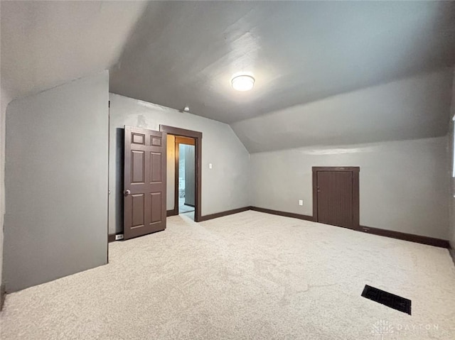 bonus room featuring carpet flooring and vaulted ceiling