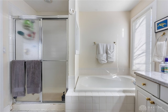 bathroom featuring vanity and shower with separate bathtub