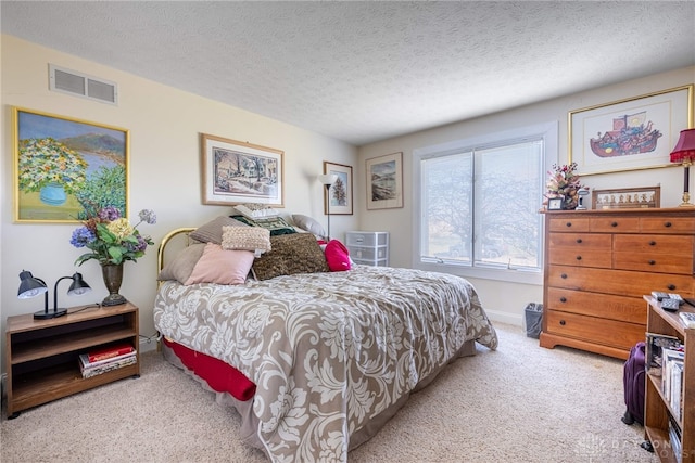 bedroom with light carpet and a textured ceiling