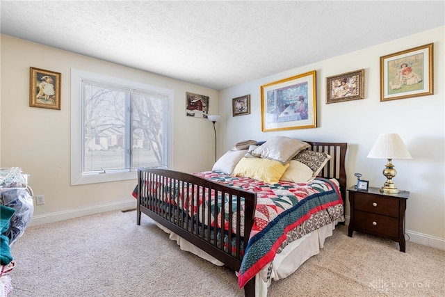 bedroom featuring light colored carpet and a textured ceiling