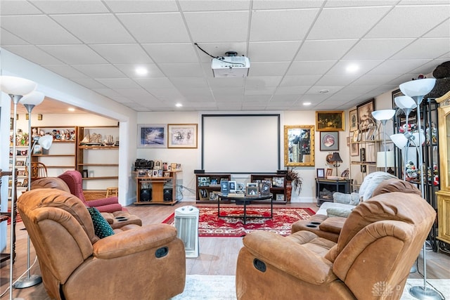 home theater featuring a paneled ceiling and hardwood / wood-style floors