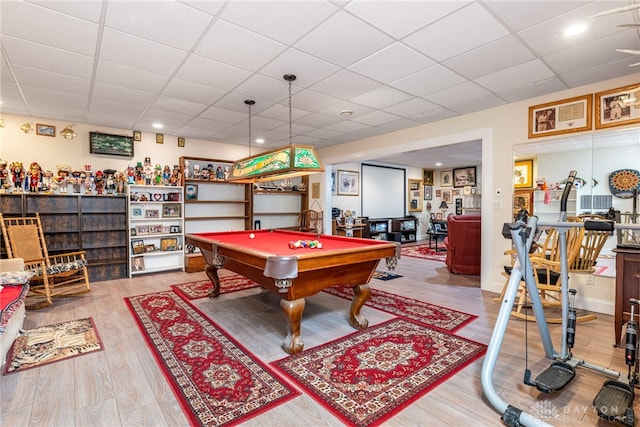 rec room with hardwood / wood-style flooring, a drop ceiling, and billiards