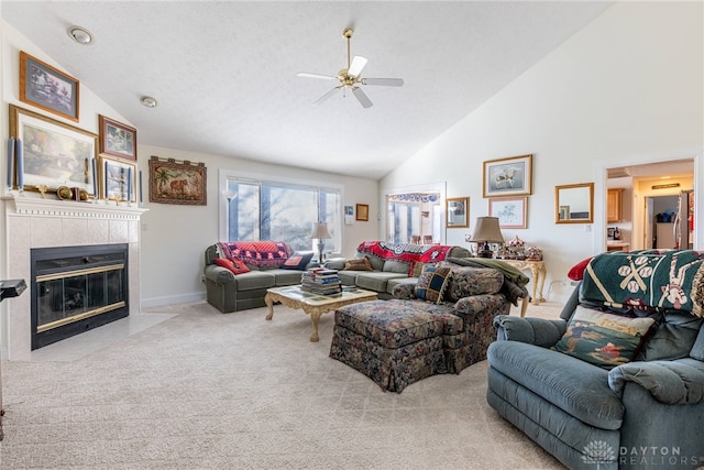 living room featuring ceiling fan, high vaulted ceiling, light colored carpet, a textured ceiling, and a fireplace